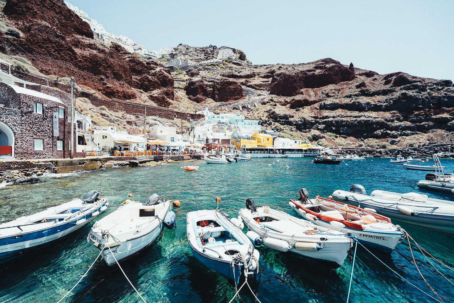 Amoudi Bay is the old port of Santorini below Oia. A tiny fishing village with a rocky beach, waterside tavernas, cliff jumping & sunsets.